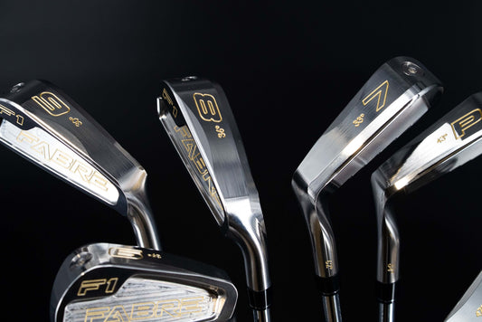 Fabre F1 Irons displayed on a black background, showcasing precision design and craftsmanship for enhanced golf performance.